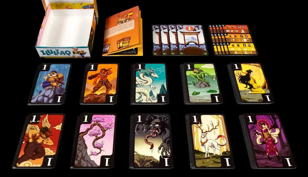 Contenido completo del juego Yokai Pagoda: cartas, manual y marcadores sobre fondo negro